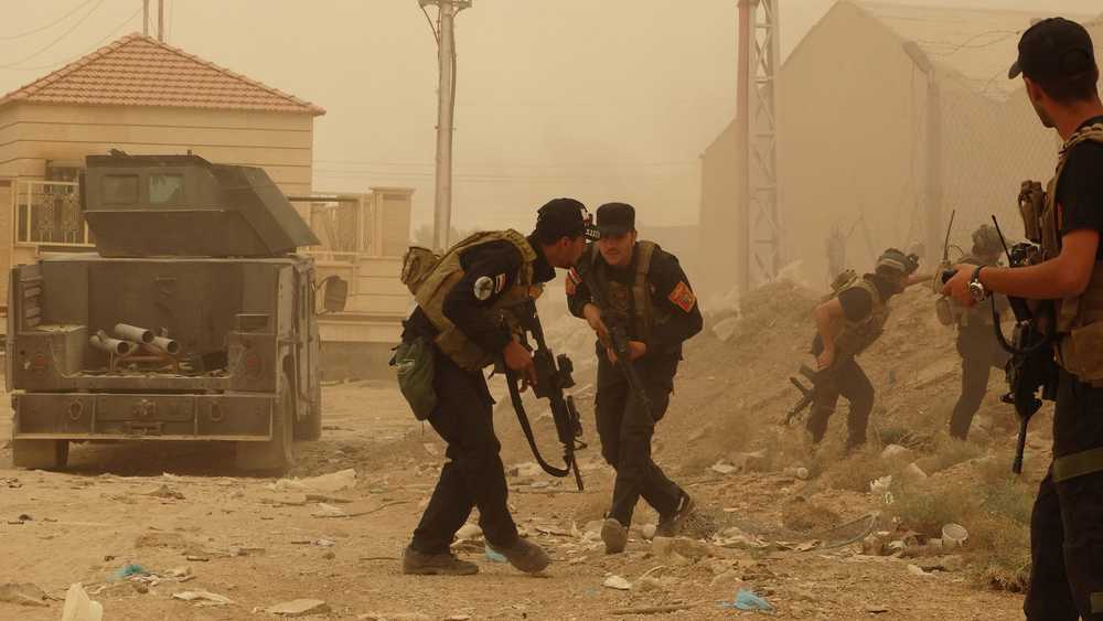 Security forces defend their headquarters against attacks by Islamic State extremists during sand storm in the eastern part of Ramadi, the capital of Anbar province, 115 kilometers (70 miles) west of Baghdad, Iraq, Thursday, May 14, 2015. Islamic State extremists tend to take advantage of bad weather when they attack Iraqi security forces positions, an Iraqi officer said. (AP Photo)